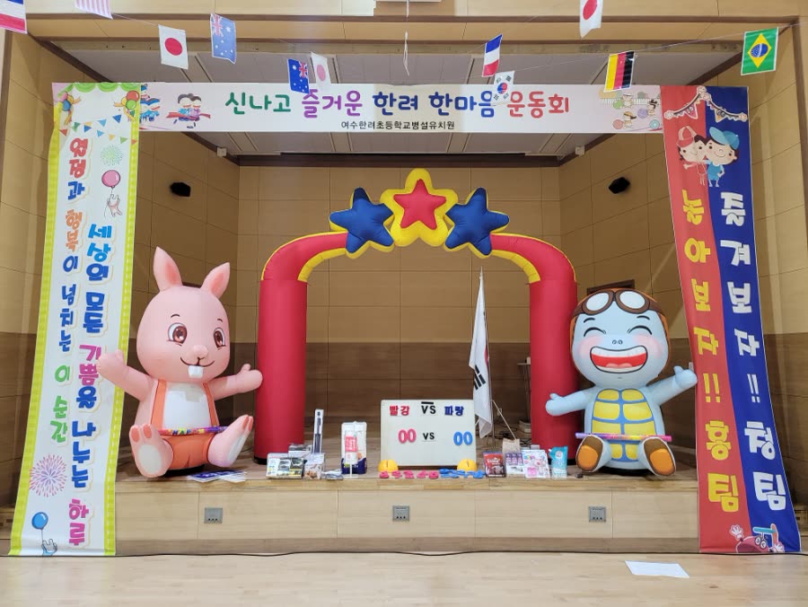 운동회 아치와 응원 현수막이 설치된 체육관 무대